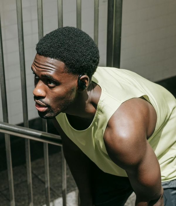 Man performing a strength training exercise in a modern gym.